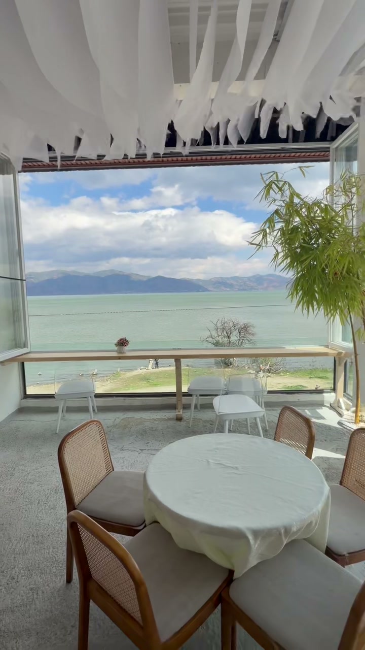 A calm highland lake seen from a light-filled dining space